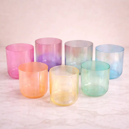 Set of colorful glass tumblers on a light background